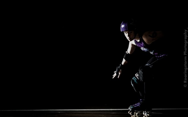 Resurrecting My Love Of Roller Skating! 13 Amy Cora in her roller derby kit in a dark moody action portrait.