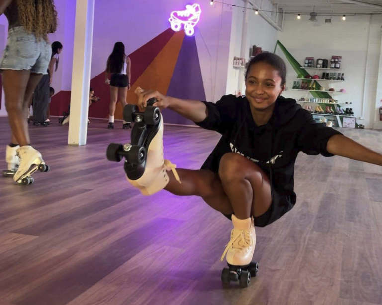 A kids party in action at RollerMart studio in Waterloo, Sydney. A young skater does a shoot the duck move on roller skates.